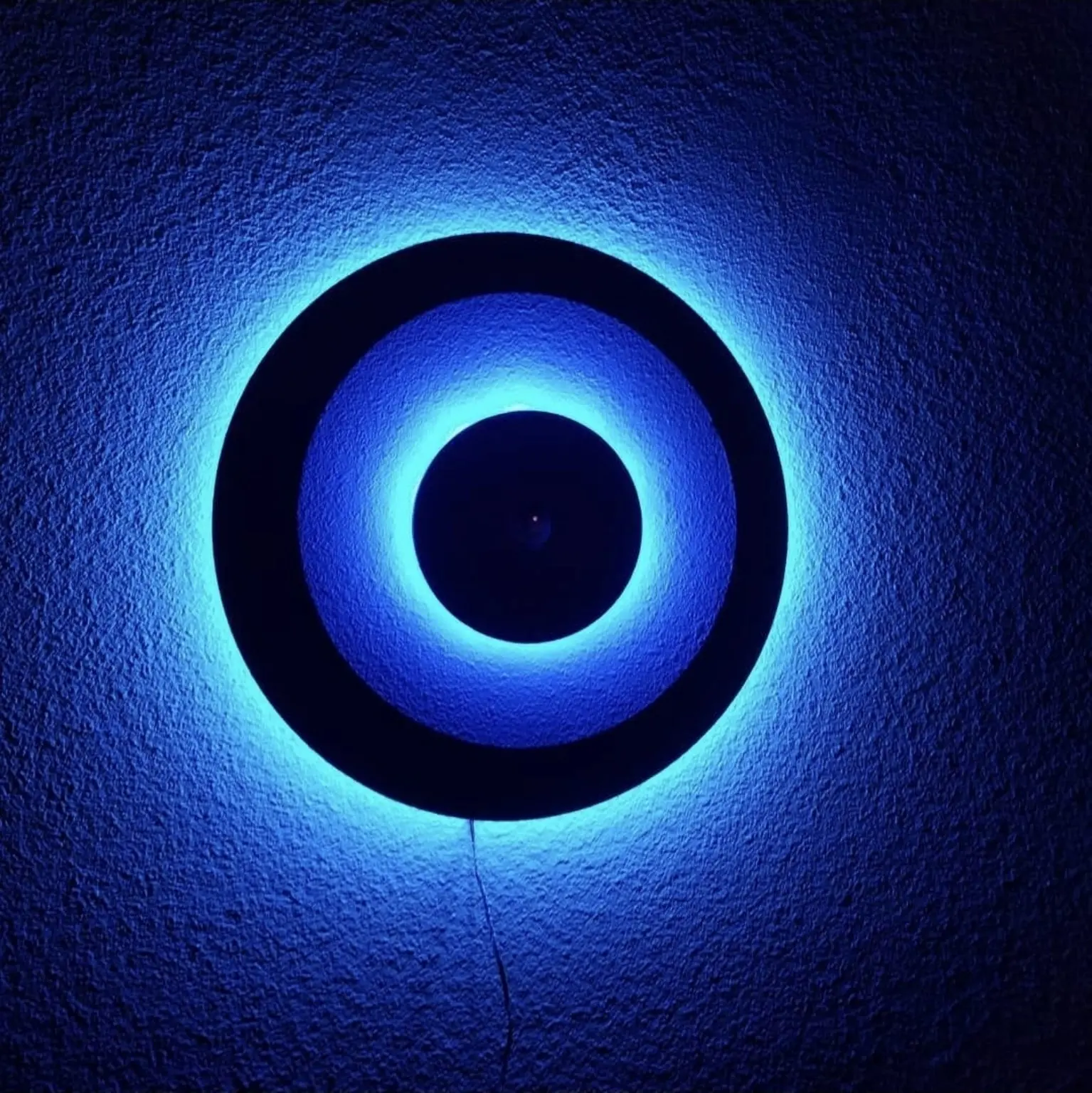 Blue halo-lit circular wall feature